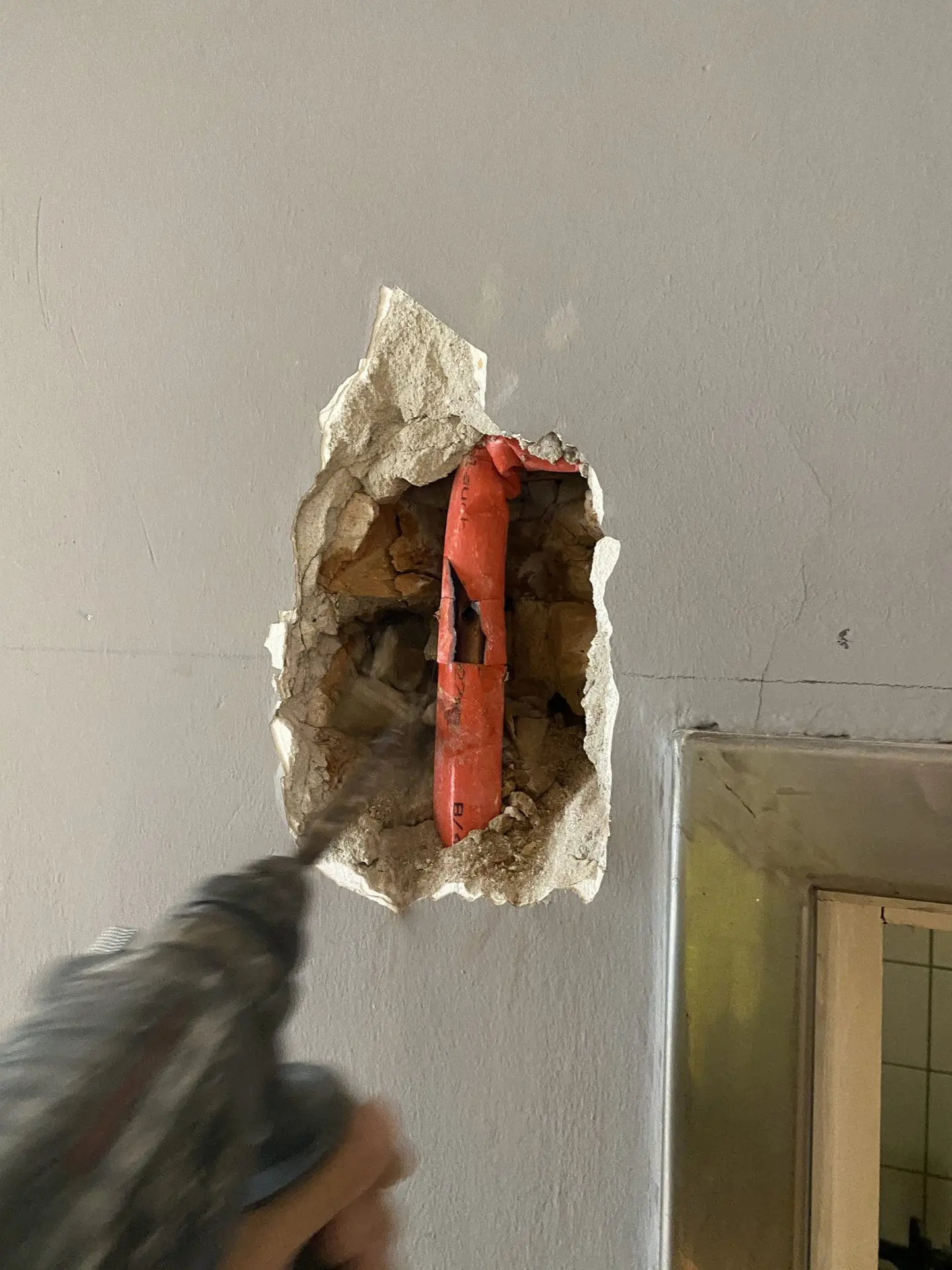 Techniker dokumentiert einen Rohrbruch im Keller